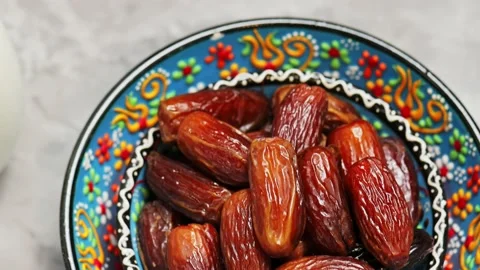 Dried dates in bowl on a gray background. Pitted dates for Ramadan Stock Footage 239861973