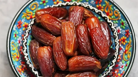 Dried dates in bowl on a gray background. Pitted dates for Ramadan Stock Footage 239862049