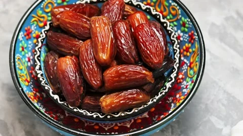 Dried dates in bowl on a gray background. Pitted dates for Ramadan Stock Footage 239862074