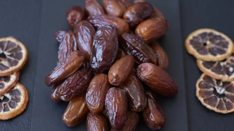 Dried dates on a ceramic plate for Ramadan or Iftar. Dates fruit as a background Stock Footage 331163077