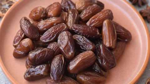 Dried dates on a ceramic plate for Ramadan or Iftar. Dates fruit as a background Stock Footage 331163089