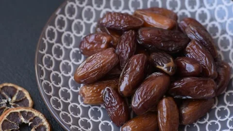 Dried dates on a ceramic plate for Ramadan or Iftar. Dates fruit as a background Stock Footage 331163091