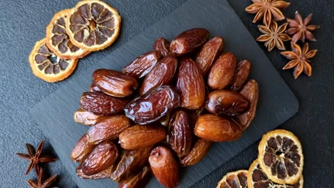 Dried dates on a ceramic plate for Ramadan or Iftar. Dates fruit as a background Stock Footage 331163143