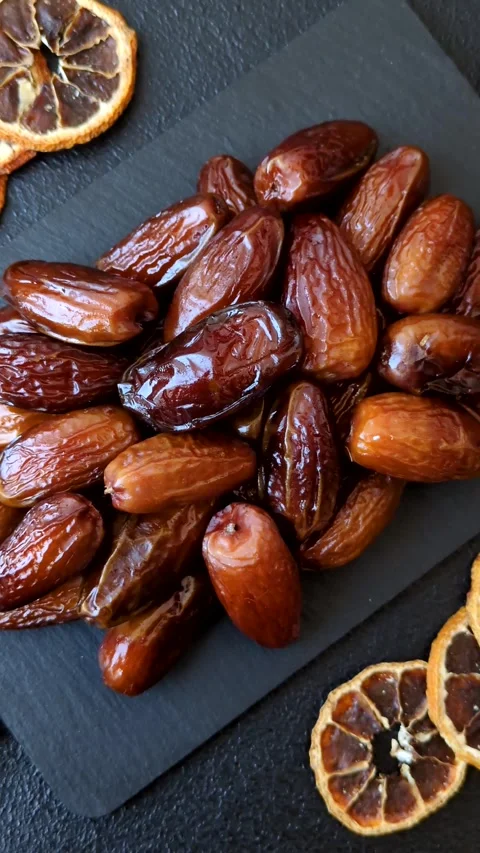 Dried dates on a ceramic plate for Ramadan or Iftar. Dates fruit as a background Stock Footage 331163148