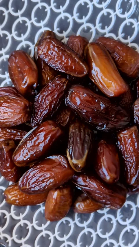Dried dates on a ceramic plate for Ramadan or Iftar. Dates fruit as a background Stock Footage 331163172