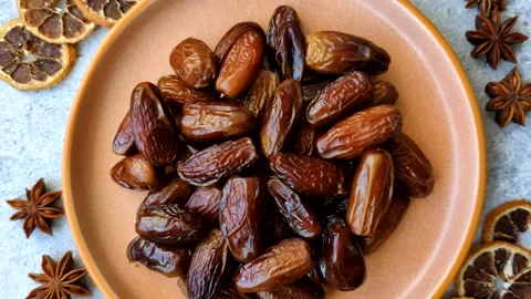 Dried dates on a ceramic plate for Ramadan or Iftar. Dates fruit as a background Stock Footage 331163180
