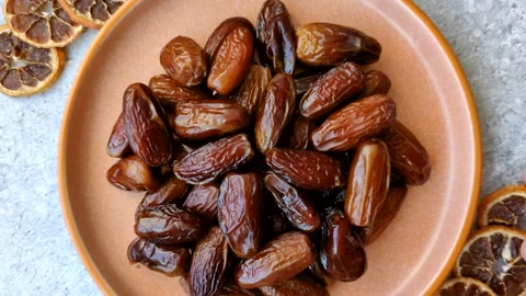 Dried dates on a ceramic plate for Ramadan or Iftar. Dates fruit as a background Stock Footage 331163182