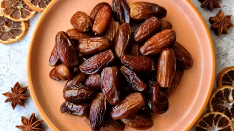 Dried dates on a ceramic plate for Ramadan or Iftar. Dates fruit as a background Stock Footage 331163184