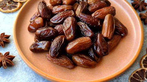 Dried dates on a ceramic plate for Ramadan or Iftar. Dates fruit as a background Stock Footage 331163187