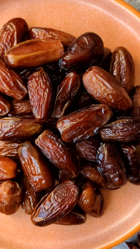 Dried dates on a ceramic plate for Ramadan or Iftar. Dates fruit as a background Stock Footage 331163194