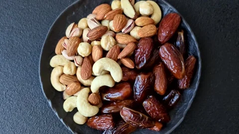 Dried dates on a ceramic plate for Ramadan or Iftar. Dates fruit as a background Stock Footage 331163214
