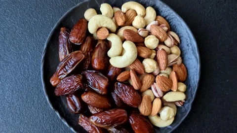 Dried dates on a ceramic plate for Ramadan or Iftar. Dates fruit as a background Stock Footage 331163216
