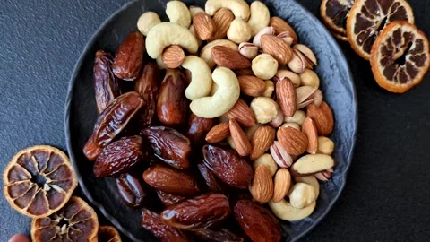 Dried dates on a ceramic plate for Ramadan or Iftar. Dates fruit as a background Stock Footage 331163217
