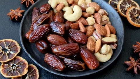 Dried dates on a ceramic plate for Ramadan or Iftar. Dates fruit as a background Stock Footage 331163224