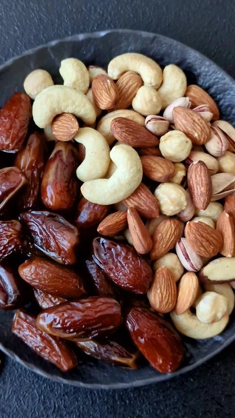 Dried dates on a ceramic plate for Ramadan or Iftar. Dates fruit as a background Stock Footage 331163225