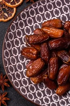 Dried dates on a ceramic plate for Ramadan or Iftar. Dates fruit as a backg.. Stock Photos