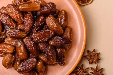 Dried dates on a ceramic plate for Ramadan or Iftar. Dates fruit as a backg.. Stock Photos