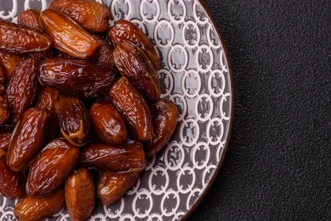 Dried dates on a ceramic plate for Ramadan or Iftar. Dates fruit as a backg.. Stock Photos