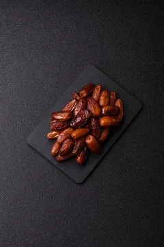Dried dates on a ceramic plate for Ramadan or Iftar. Dates fruit as a backg.. Stock Photos