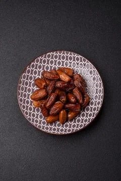 Dried dates on a ceramic plate for Ramadan or Iftar. Dates fruit as a backg.. Stock Photos