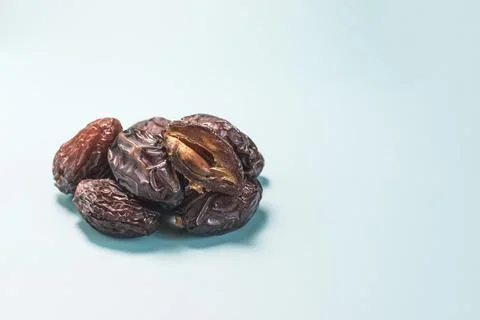Dried dates close-up on a light blue background of natural light. Stock Photos
