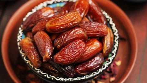 Dried dates close up. Sweet pitted dates in bowl. Ramadan Kareem Stock Footage 237400786