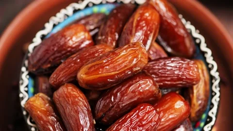 Dried dates close up. Sweet pitted dates in bowl. Ramadan Kareem Stock Footage 237400834