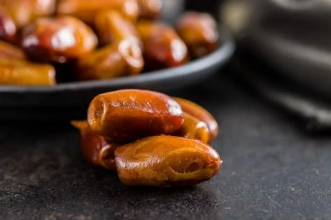 Dried dates fruit on black table. Stock Photos