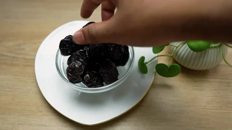 Dried Dates on Heart-Shaped Plate with Plant Stock Footage 320726100