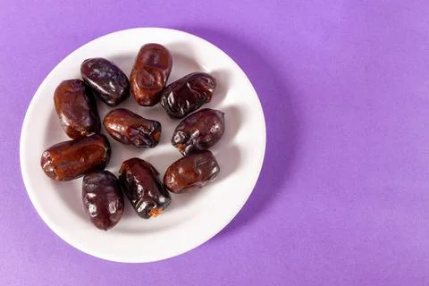 Dried dates on a purple background Stock Photos