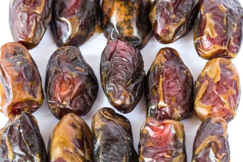 Dried dates in rows isolated on white Stock Photos