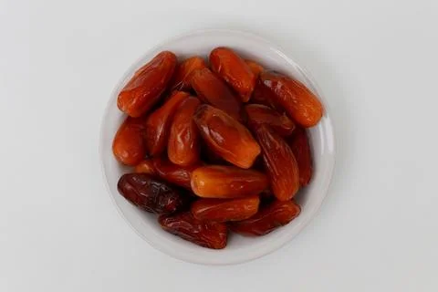 Dried dates served on a white plate Stock Photos