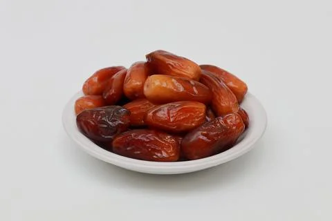 Dried dates served on a white plate Stock Photos