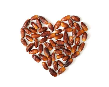 Dried dates in the shape of heart isolated on a white background.  Stock Photos