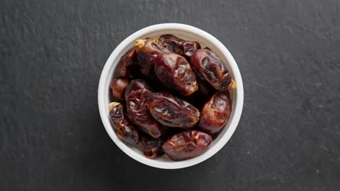 Dried dates in white bowl rotating. Pile of dried fruits. Healthy vegan food Stock Footage 292409050