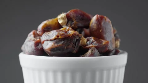 Dried dates in white bowl rotating. Pile of dried fruits. Healthy vegan food Video stock 297089888
