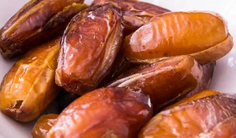 Dried dates on white plate Stock Photos