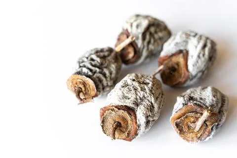 Dried, dried persimmon on a white background. Stock Photos