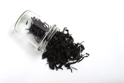 Dried, fermented willow-herb, poured from a glass jar. Isolated on a white ba Stock Photos
