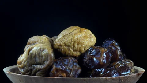 Dried figs and dates on a plate in 4K. Stock Footage 154418105