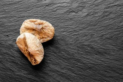 Dried Figs on Black Stone Surface Background Stock-Fotos