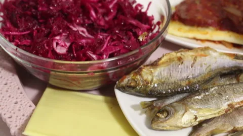Dried fish, beer and salad on a tray. The man eats fish and drinks beer. Near Stock Footage 145484852