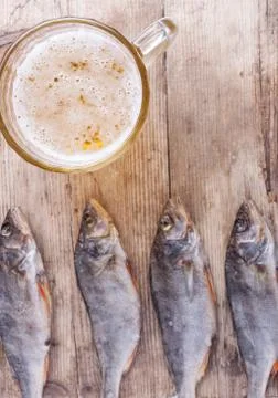 Dried fish with beer on the table top view background Stock Photos