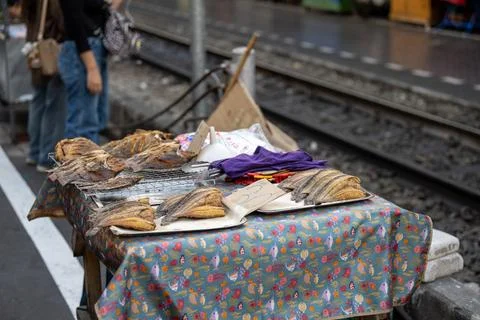 Dried fish displayed on table beside railway track Bangkok 스톡 사진