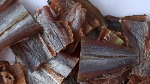 Dried fish fillet red cod amber. An appetizer for beer in full background, slow Stock Footage 229763105