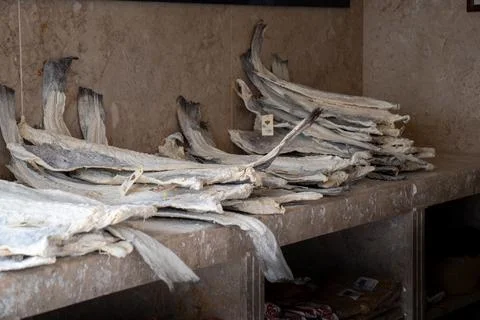 Dried Fish Fillets Stacked on a Rustic Countertop in a Traditional Market. Stock Photos
