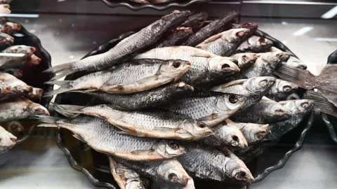 Dried fish roach, Rudd. lies on the counter in the market, salty snacks. roach Stock Footage 132389442