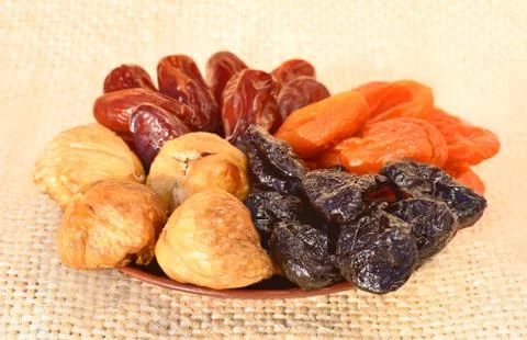 Dried fruit, dates, figs, prunes, apricots on the plate Stock Photos