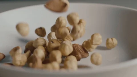 Dried Fruit Falls in Slow Motion on a White Plate Stock Footage 89901346