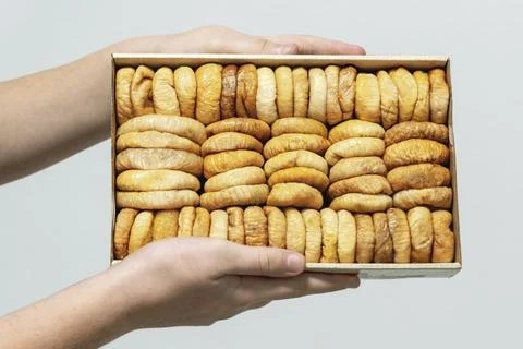 Dried fruit in hand. Rows of dried dates, apricots,cranberries, blueberries.. Stock Photos